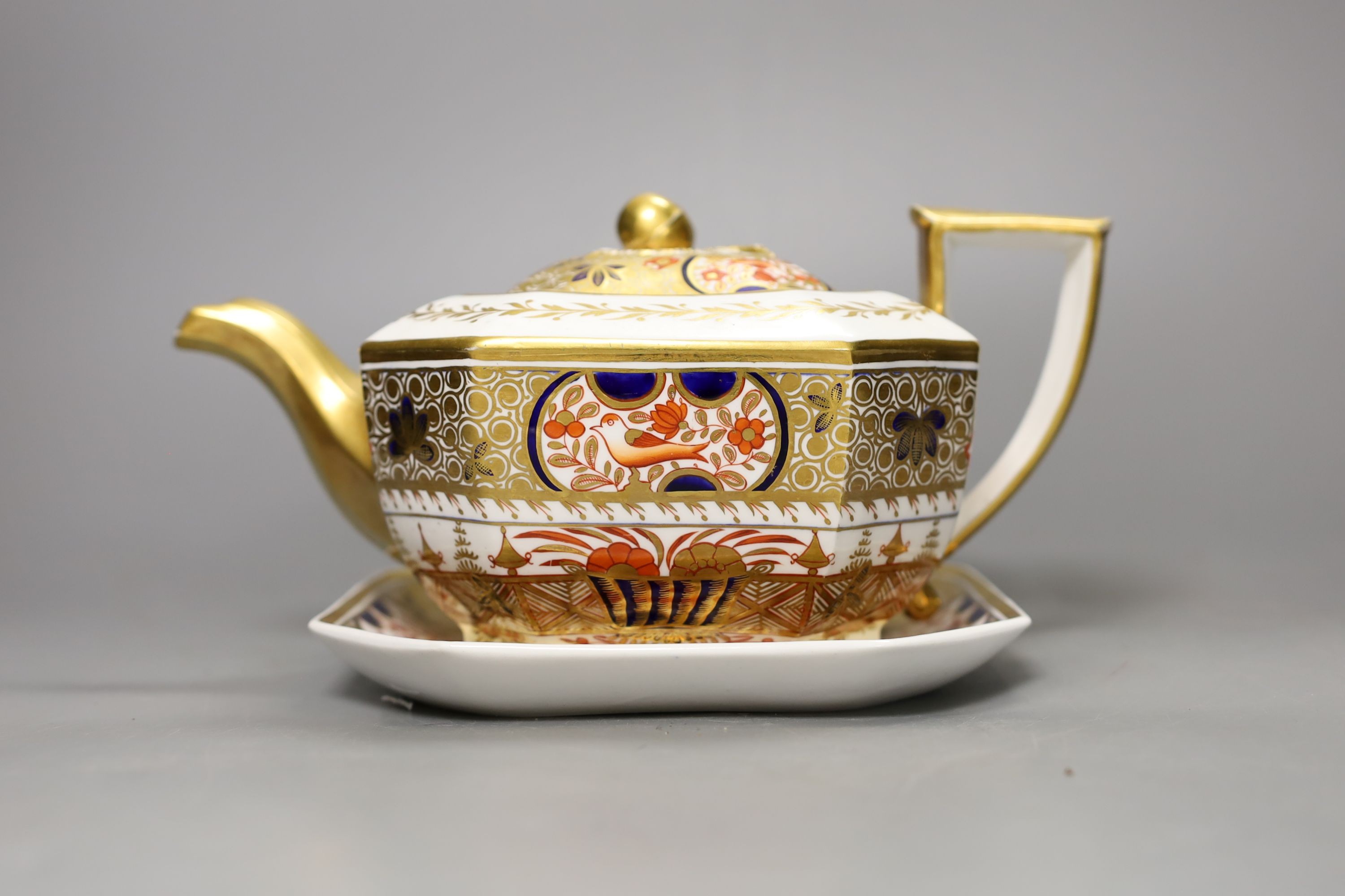A Spode teapot cover and stand painted with Imari pattern, 1495, c.1820, 24.5 cm long